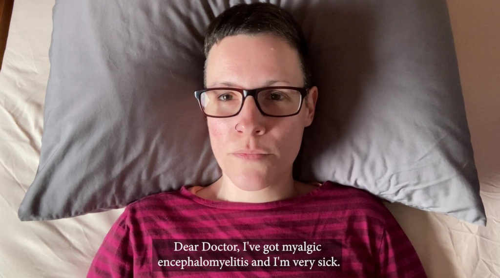 Woman in bed wearing red stripped top